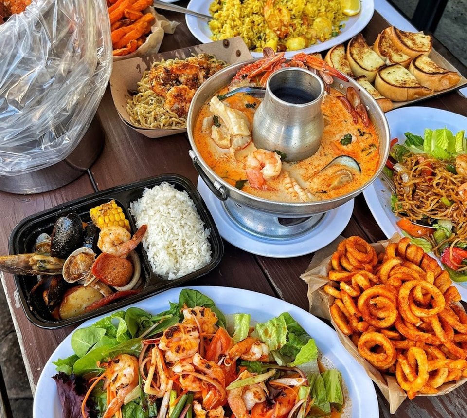 Thai and seafood dishes arranged on a table.
